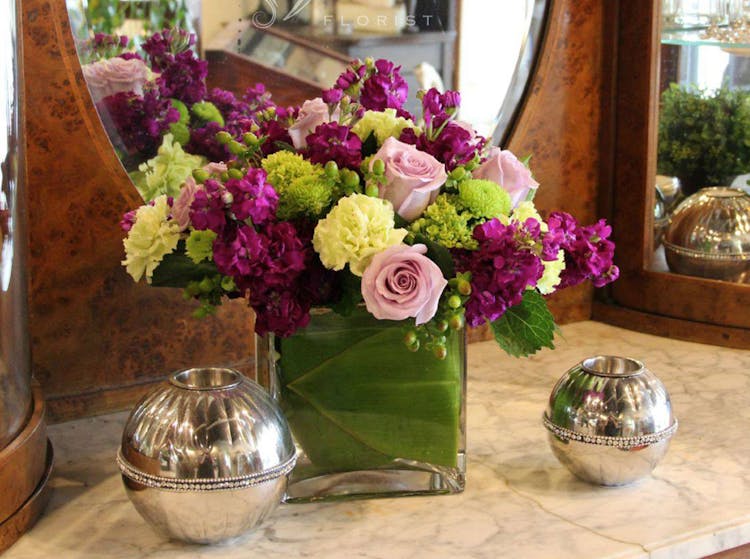A lovely arrangement of purple, pink, green and white flowers