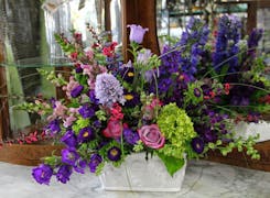 A wide range of colorful floral arrangements, awaiting their new home